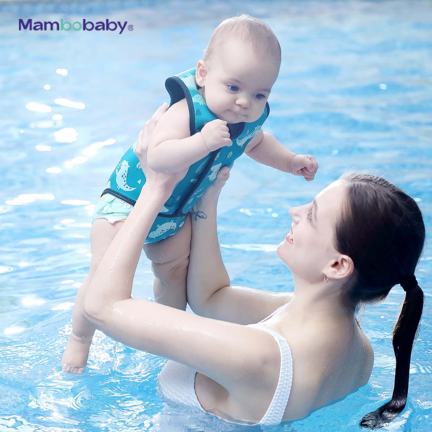 Mother lifting baby wearing Mambobaby thermal wetsuit in Dino Blue in swimming pool