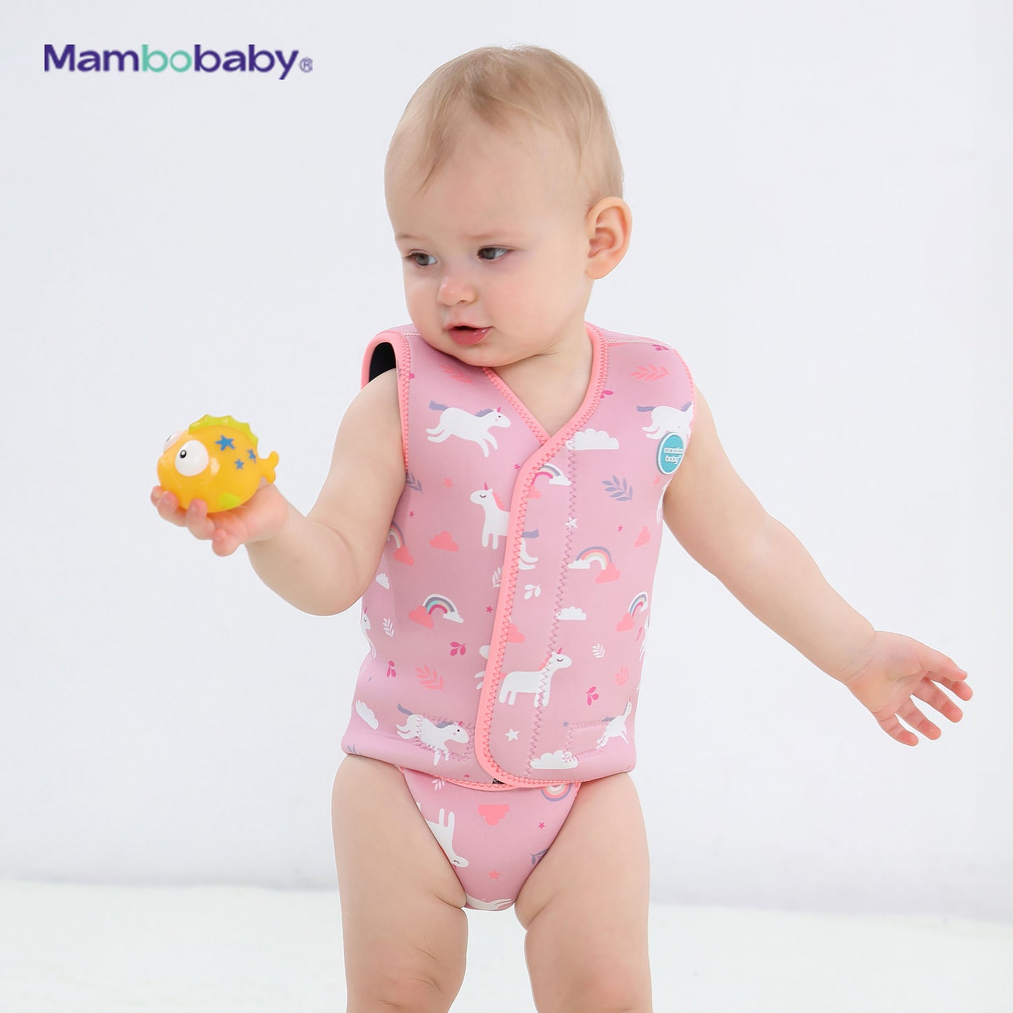 Baby standing and playing with a toy while wearing Mambobaby thermal wetsuit